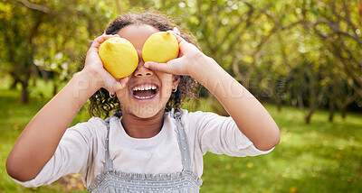 Buy stock photo Lemon on eyes, happy and girl on farm for harvest, sustainable farming and growth in nature. Agriculture, childhood and kid smile with fruit for nutrition, healthy eating and organic food in garden