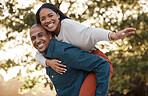 Couple, park and piggy back with smile, portrait and airplane game in nature, holiday and bonding in summer. Man, woman and playful in backyard, freedom and vacation by trees with love in sunshine