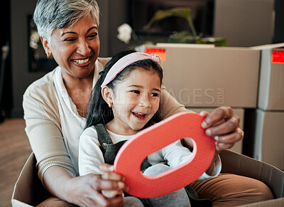 Buy stock photo Senior woman, kid and moving boxes with smile, playing and happy with grandmother, grandchild or new property. Family home, excited and enjoying at house, driving and bonding for memories, fun or joy