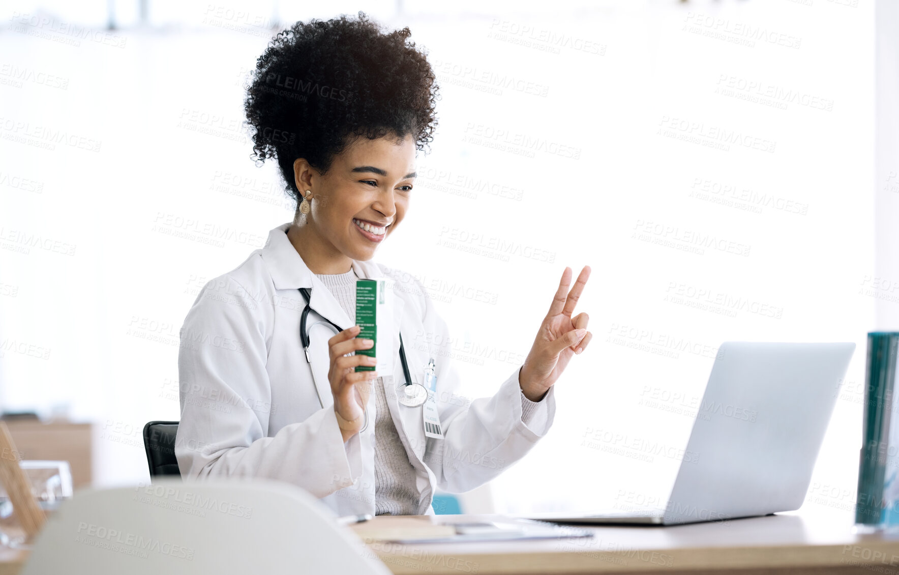 Buy stock photo Woman, doctor and laptop with video call at clinic for advice, product or peace sign for healthcare in office. Medic, nurse or pharmacist with box, drugs or emoji for telehealth consultation on pc