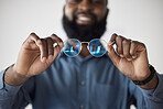 Optometry, closeup and a black man showing glasses for healthcare, consulting or an exam. Lens, happy and an African person holding prescription eyewear to check the frame for vision or eye care