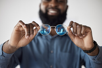 Buy stock photo Optometry, closeup and a black man showing glasses for healthcare, consulting or an exam. Lens, happy and an African person holding prescription eyewear to check the frame for vision or eye care