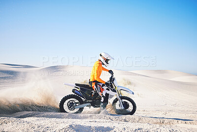 Buy stock photo Extreme sport, motorcycle and athlete with sand by wheels with pride, skill and adrenaline rush.  Biker, sunshine and dust with blue sky in fun, fitness and achievement in speed, race and lens flare 