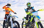 Moto, rider and competitive in desert for sports with pose after practice for competition. Dubai, people and workout to relax on holiday, vacation or travel for race to win with tournament in summer