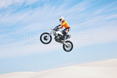 Motorcycle, jump and man in the air with blue sky, mock up and stunt in sports with fearless person in danger with freedom. Motorbike, jumping and athlete training for challenge or competition
