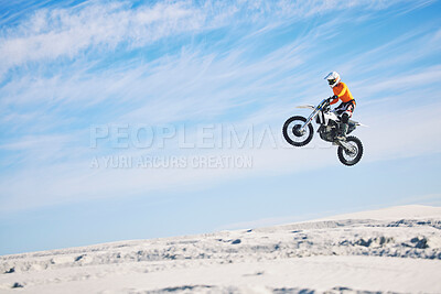 Buy stock photo Motorcycle, desert and jump for sports in race, adrenaline and training for fitness in competition. Athlete, sky and mockup for freedom, driving and dirtbike in outdoor for stunt or performance