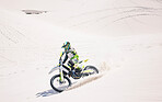 Man, driving and motorbike on sand for sport, adventure or competition outdoor in summer and mockup space. Motorcycle, ride and athlete on dirt, dune or desert for race, danger and fearless challenge