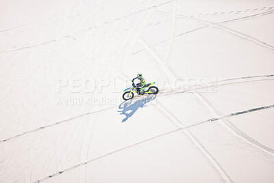 Buy stock photo Above, man and driving motorbike on sand for sport, adventure or outdoor track in summer or mockup space. Motorcycle, ride and athlete on dirt, dune or desert for race, danger and fearless challenge
