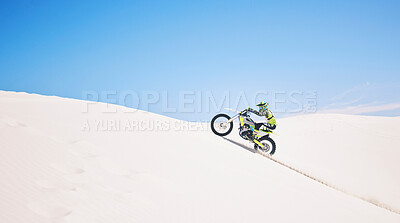 Buy stock photo Man, driving and motorbike on sand with blue sky or sport, adventure and outdoor race in summer or mockup space. Motorcycle, ride and athlete on off road, dirt or desert for challenge and danger