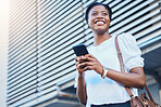 Phone, smile and young woman in the city networking on social media, mobile app or the internet. Happy, technology and African female person scroll on cellphone and walking in urban town street.