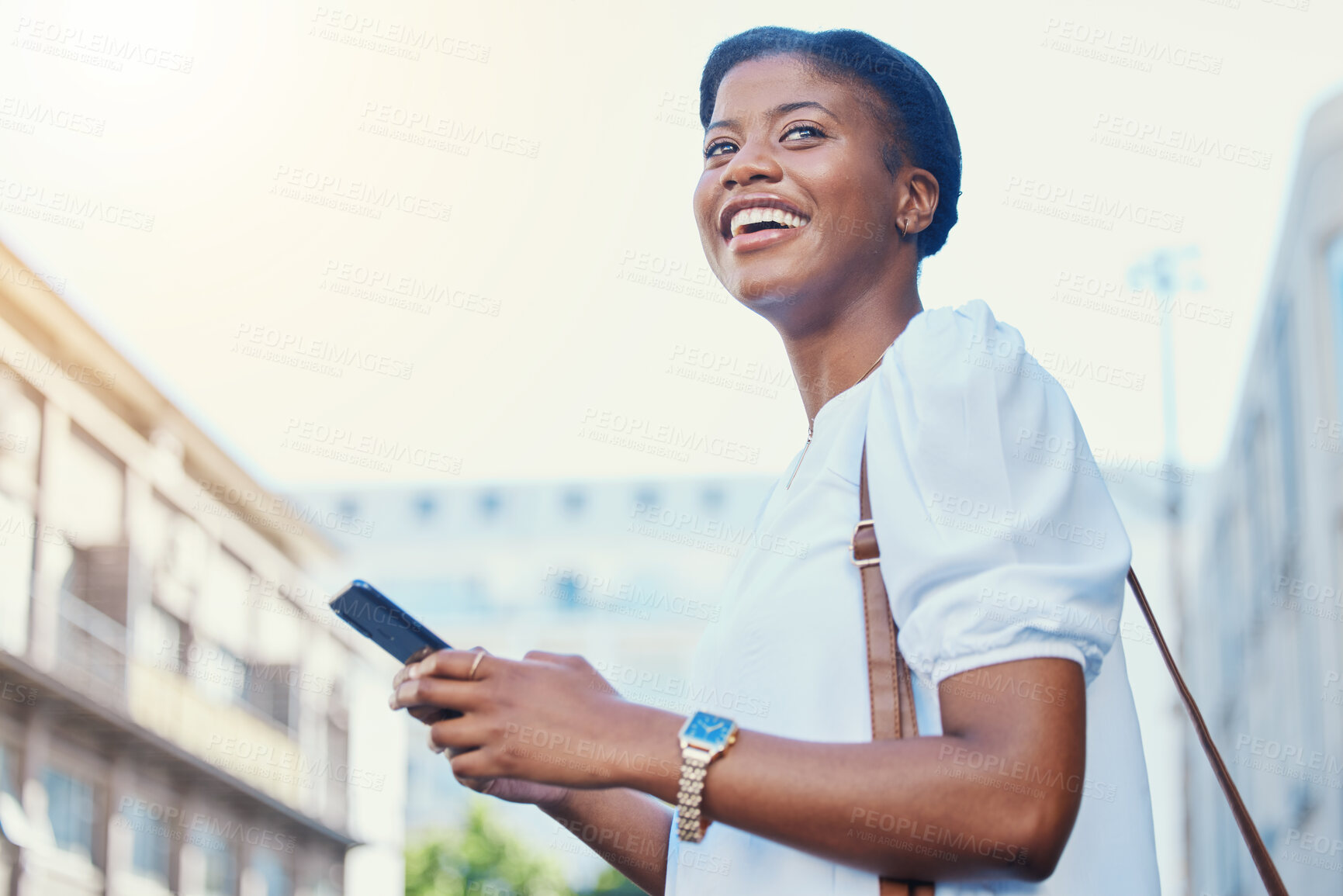 Buy stock photo Phone, happy and young woman in the city networking on social media, mobile app or the internet. Smile, technology and African female person scroll on cellphone and walking in urban town street.