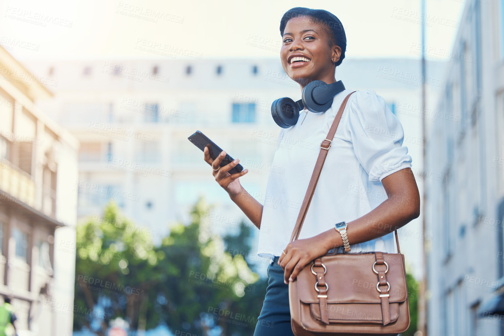 Buy stock photo Phone, walking and young woman in the city networking on social media, mobile app or the internet. Happy, technology and African female person scroll on cellphone and commuting in urban town street.