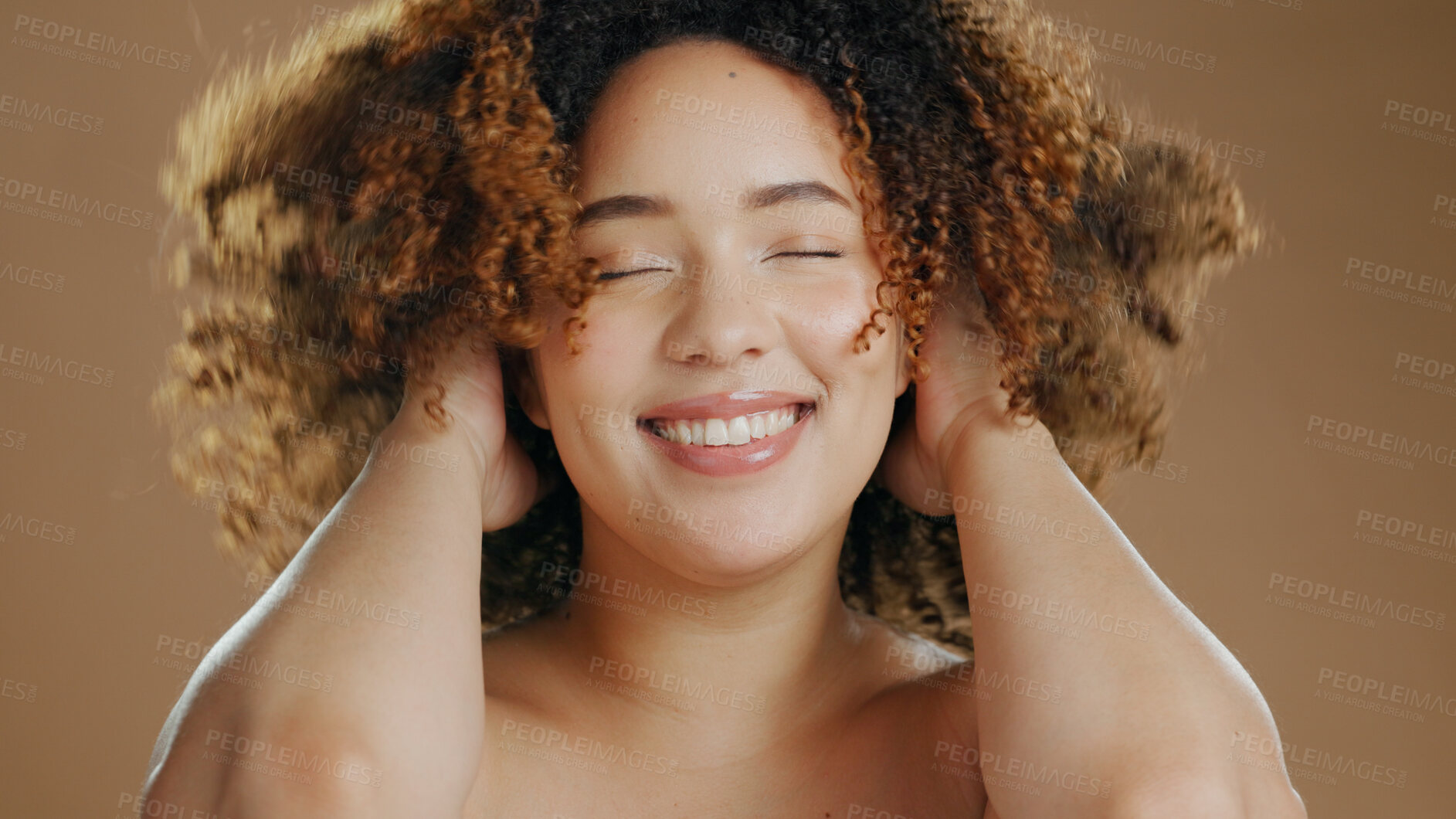 Buy stock photo Happy woman, curly hair or natural beauty dermatology for wellness in studio with smile or skin glow. Face, smile or confident biracial female person with skincare cosmetics on a brown background