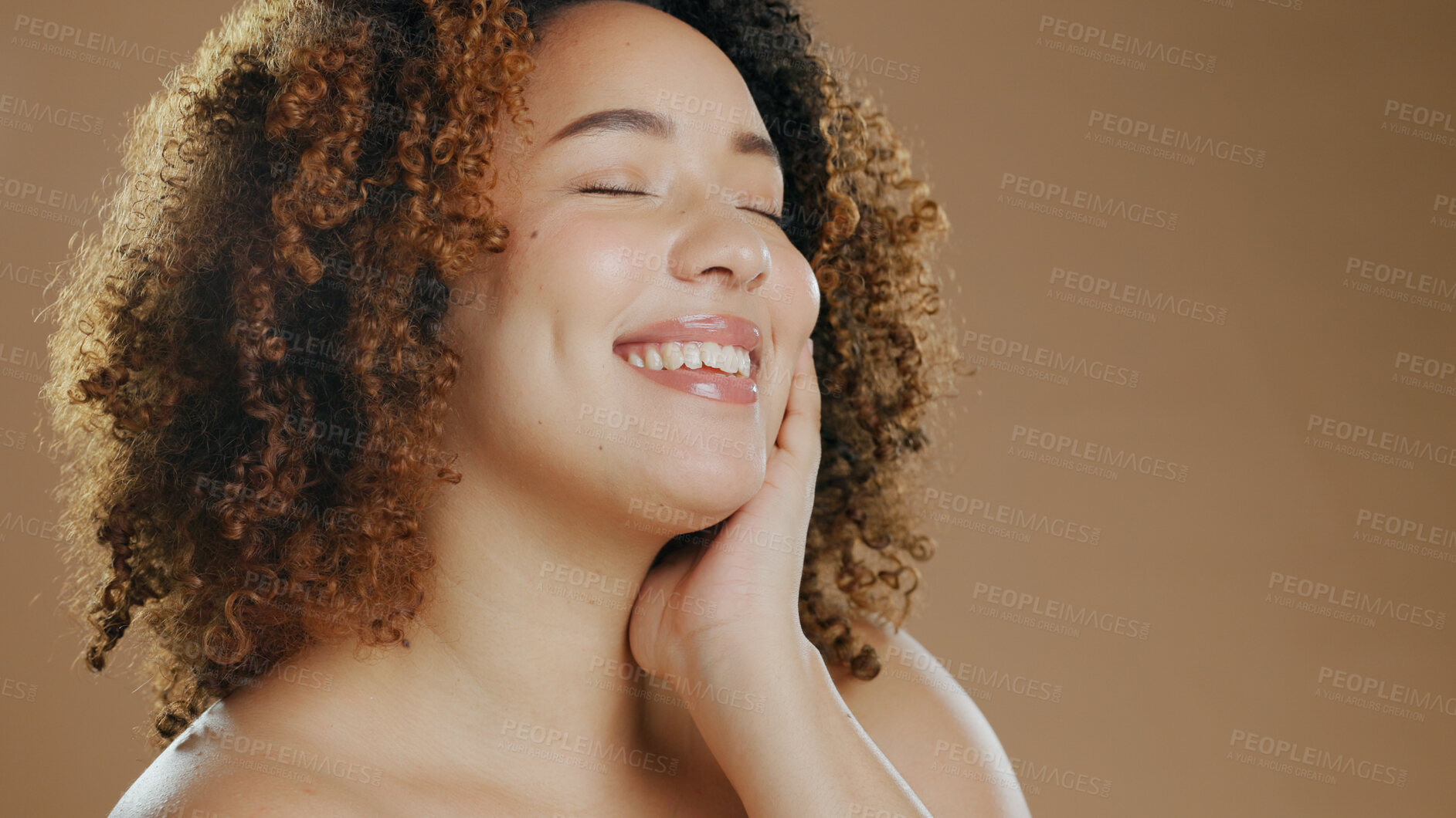 Buy stock photo Face of happy woman, natural beauty mockup space or cosmetics for wellness in studio with smile. Skin glow, pride or confident biracial female model with skincare results isolated on brown background