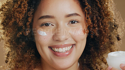 Buy stock photo Black woman, skincare and cream on face for dermatology, beauty or happiness on brown background in studio. Skin, care or happy portrait with cosmetics, lotion or sunscreen for  facial wellness