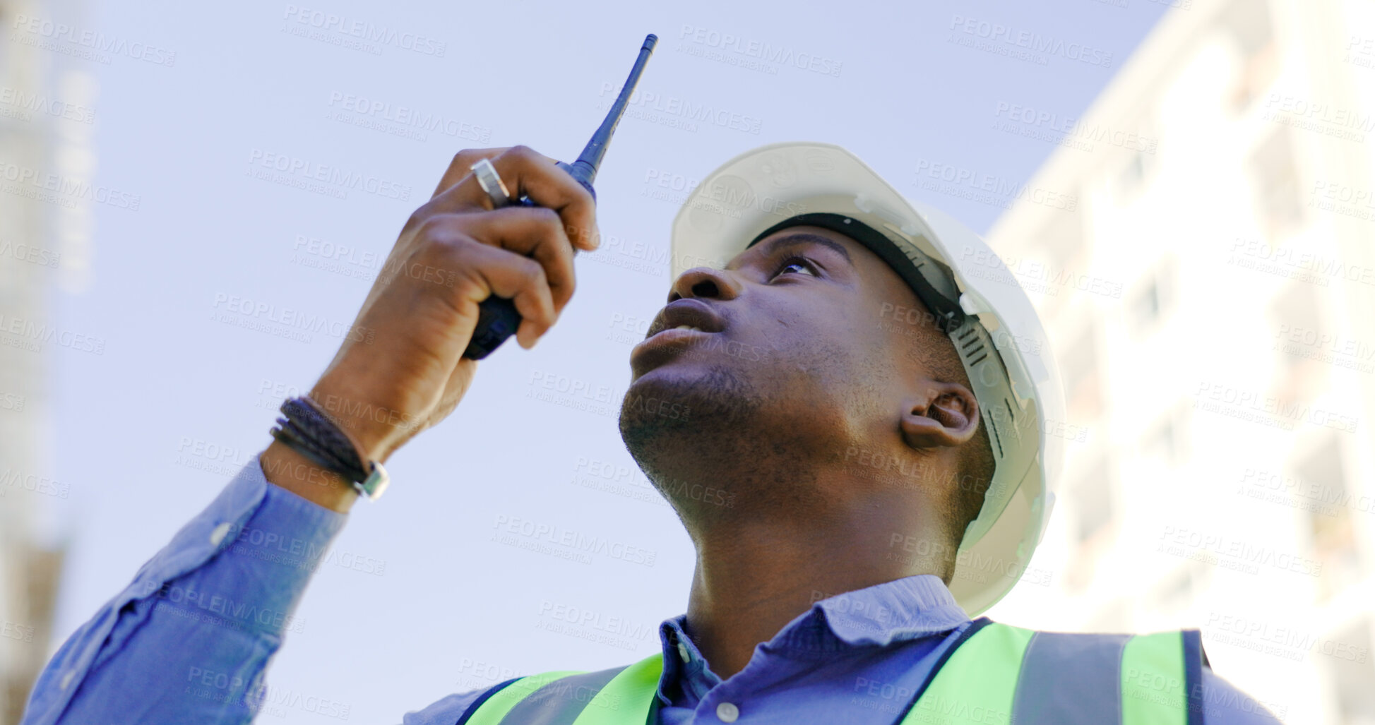 Buy stock photo Communication, radio and construction worker, man or manager for project management in urban city. African builder in engineering inspection, building progress or architecture survey on walkie talkie