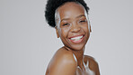 Portrait, beauty and smile with a happy black woman in studio on a gray background for natural wellness. Face, skincare and cosmetics with a happy young model closeup on space for luxury aesthetic