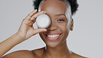 Happy black woman, face and skincare cream for beauty, cosmetics against a studio background. Portrait of African female person or model smile with lotion, moisturizer or creme for facial treatment