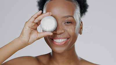 Buy stock photo Happy black woman, face and skincare cream for beauty, cosmetics against a studio background. Portrait of African female person or model smile with lotion, moisturizer or creme for facial treatment
