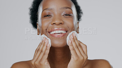 Buy stock photo Woman, model and cotton pad on face with skincare, toner and happiness in advertisement, cosmetics and studio. Black lady, glowing skin and dermatology for cleanser, wipe and beauty with aesthetic