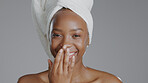 Portrait, beauty and cream with a happy black woman in studio on a gray background for natural wellness. Face, skincare and lotion with a happy young model closeup to apply treatment to her skin