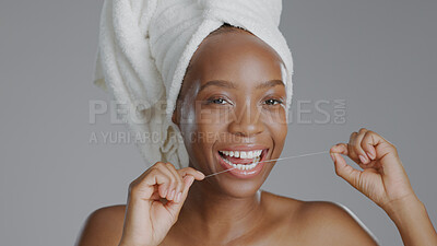 Buy stock photo Portrait, beauty and dental floss with a happy black woman in studio on a gray background for natural wellness. Oral hygiene, teeth and cleaning with a happy young model closeup for dentistry