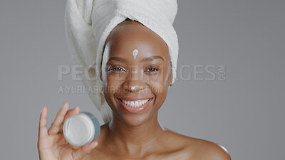 Buy stock photo Woman, moisturizer and smile in portrait for skincare or beauty, health and wellness or dermatology. Happy black person, skin and cosmetics with glow, care and cream in studio by gray background