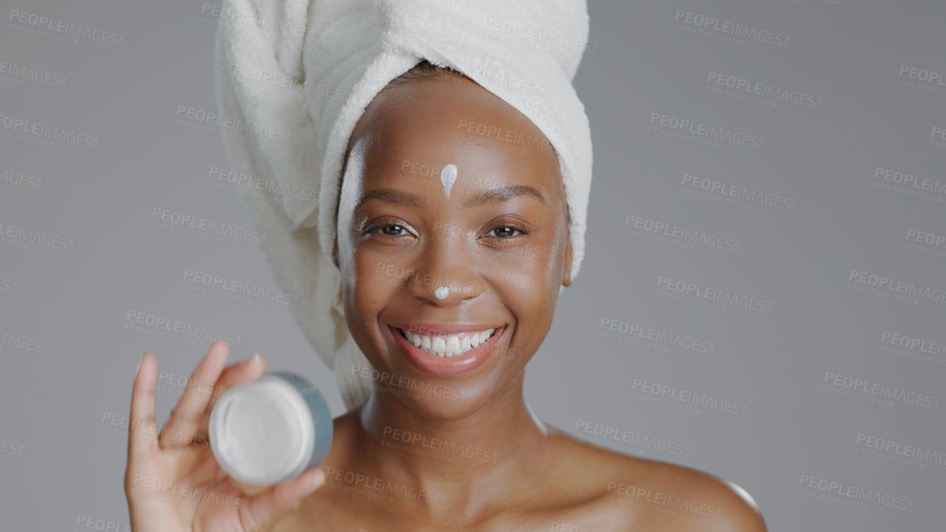 Buy stock photo Woman, moisturizer and smile in portrait for skincare or beauty, health and wellness or dermatology. Happy black person, skin and cosmetics with glow, care and cream in studio by gray background