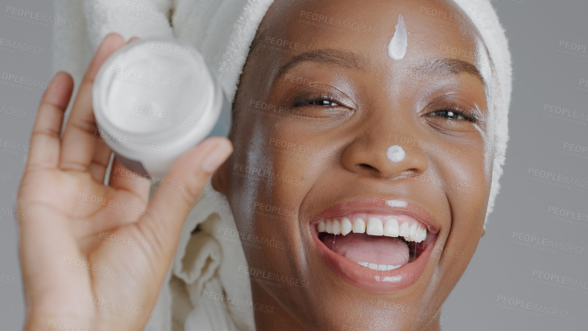 Buy stock photo Woman, moisturizer and smile in portrait for skincare or beauty, health and wellness or dermatology. Happy black person, skin and cosmetics, care and cream on face in studio by gray background