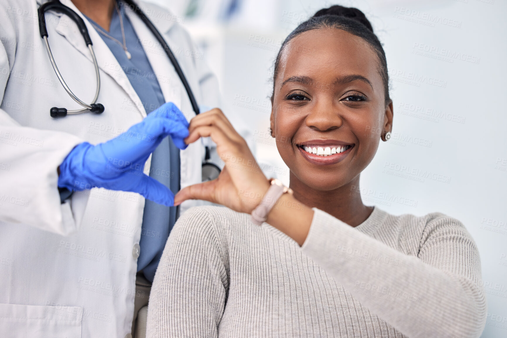 Buy stock photo Black woman, patient and doctor with smile, consultation and heart emoji for cardio health, checkup and appointment. Happiness, support and wellness for medicine, healthcare and physical examination