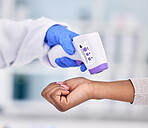 Doctor, hands and thermometer for patient temperature, fever or checkup appointment at hospital. Closeup of medical nurse or surgeon checking customer with infrared scanner for virus or flu at clinic