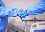 Doctor, team and handshake with gloves in partnership, meeting or introduction together at hospital. Closeup of medical nurse or employees shaking hands in teamwork for deal or agreement at clinic