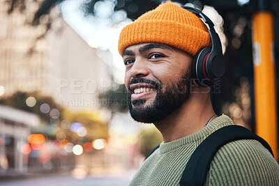 Buy stock photo Smile, music headphones and man in city outdoor, listening to audio or sound track on internet to travel. Radio, streaming podcast and happy person hearing media online, freedom or thinking in street