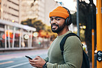 Phone, headphones and portrait of man in city outdoor, listen to audio or radio sound on internet to travel. Face, streaming music and happy student typing in street on social media in South Africa