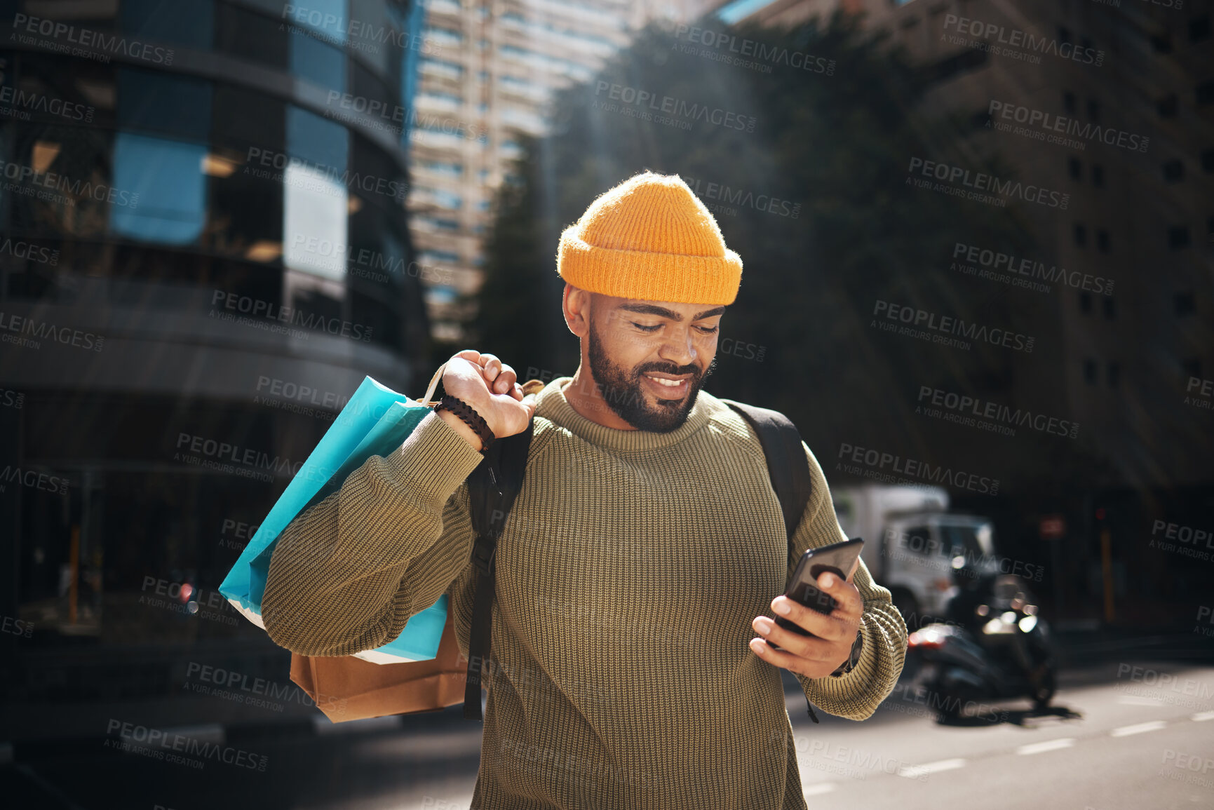 Buy stock photo Student, phone and shopping bag in city travel, walking and search for student deal, discount or online sale. Happy african man with retail gift and mobile app, social media and chat in urban street