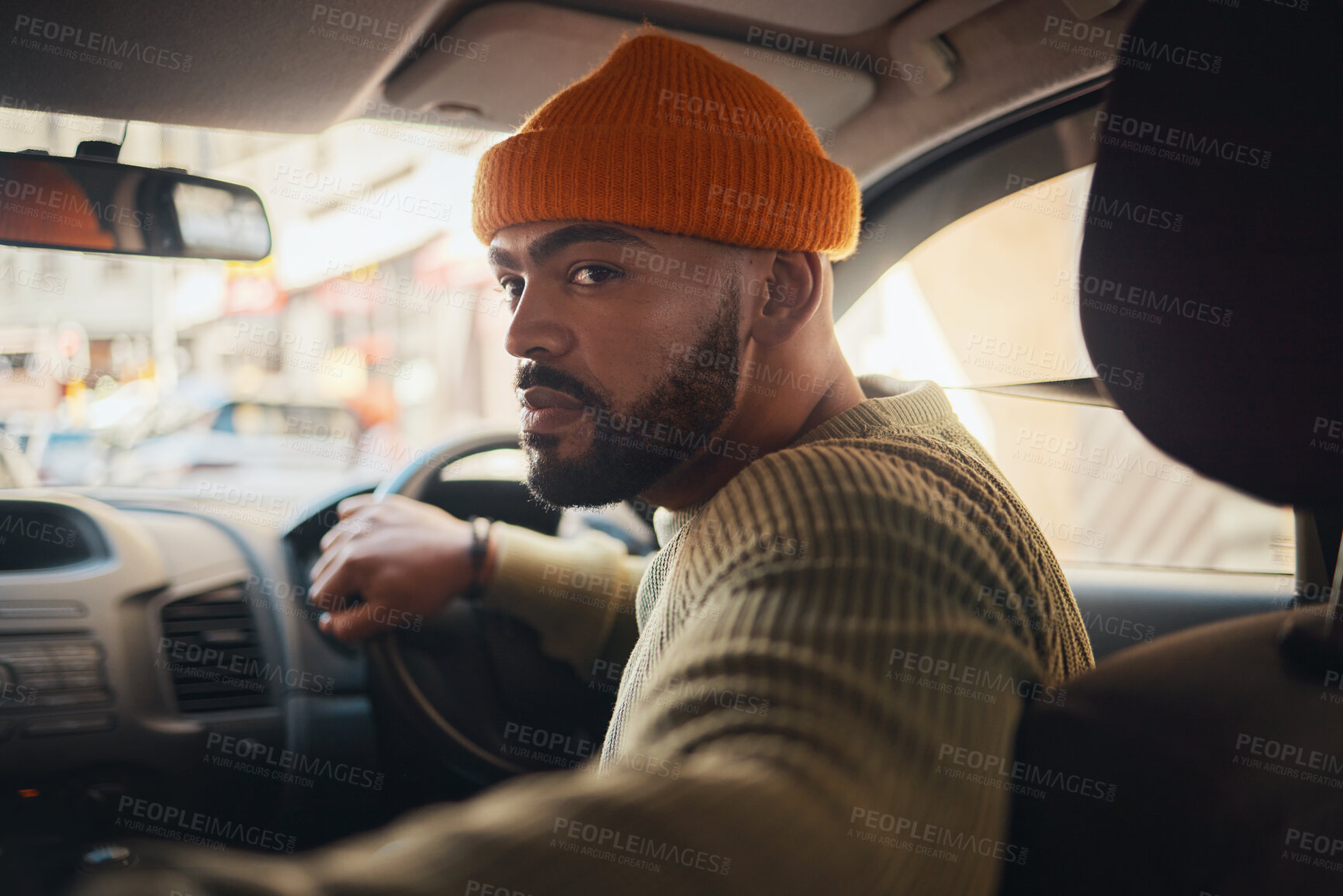 Buy stock photo Taxi, ride and man driving in a car as city transport or vehicle travel to a destination in town and looking for parking. Serious, back and person in lift service reverse in a street or location