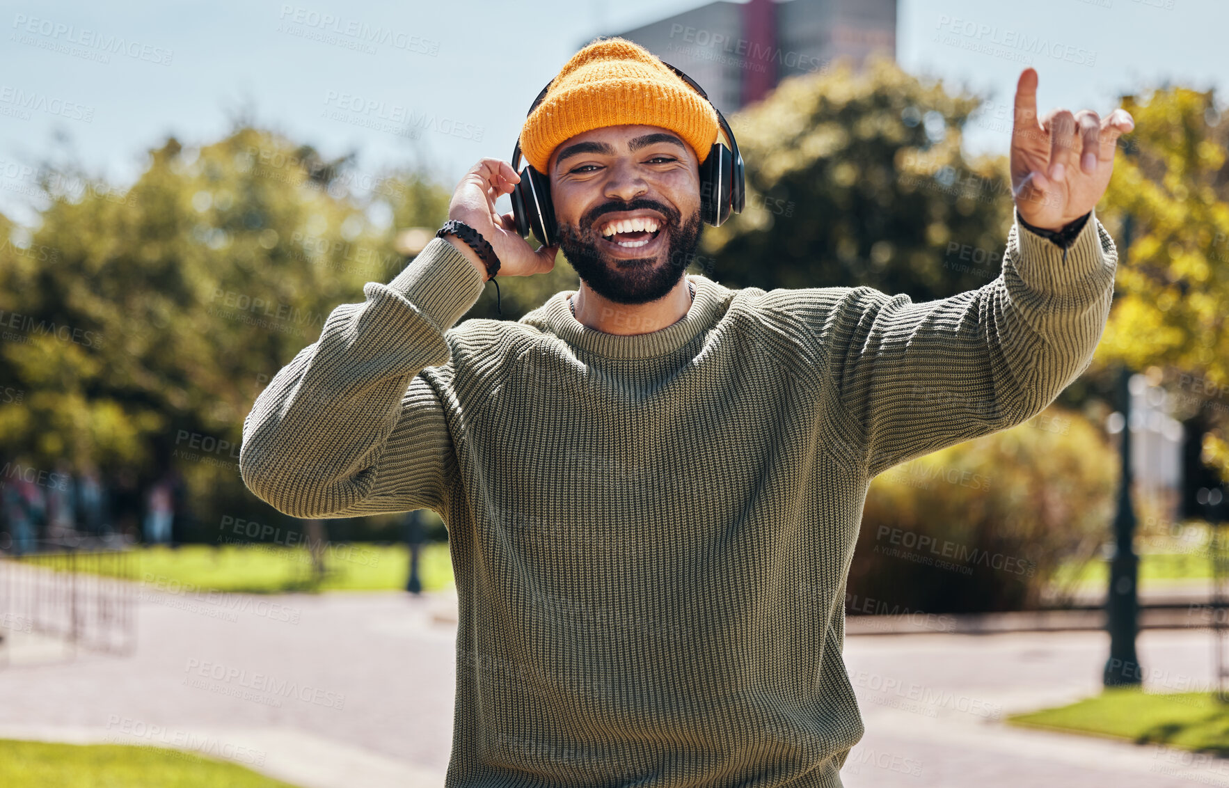 Buy stock photo Music, headphones and portrait of happy man at park outdoor, listening to audio online or hearing sound on podcast technology. Face, streaming radio and person dance in garden for freedom in nature