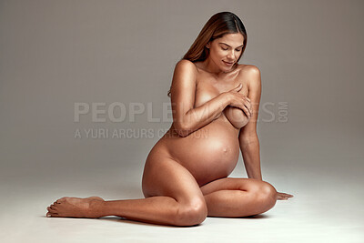 Buy stock photo Woman, maternity and naked in pregnancy, studio and nude by gray background in mockup on floor. Pregnant female, mother and nudity in photoshoot, art deco and model in pose for creative reveal