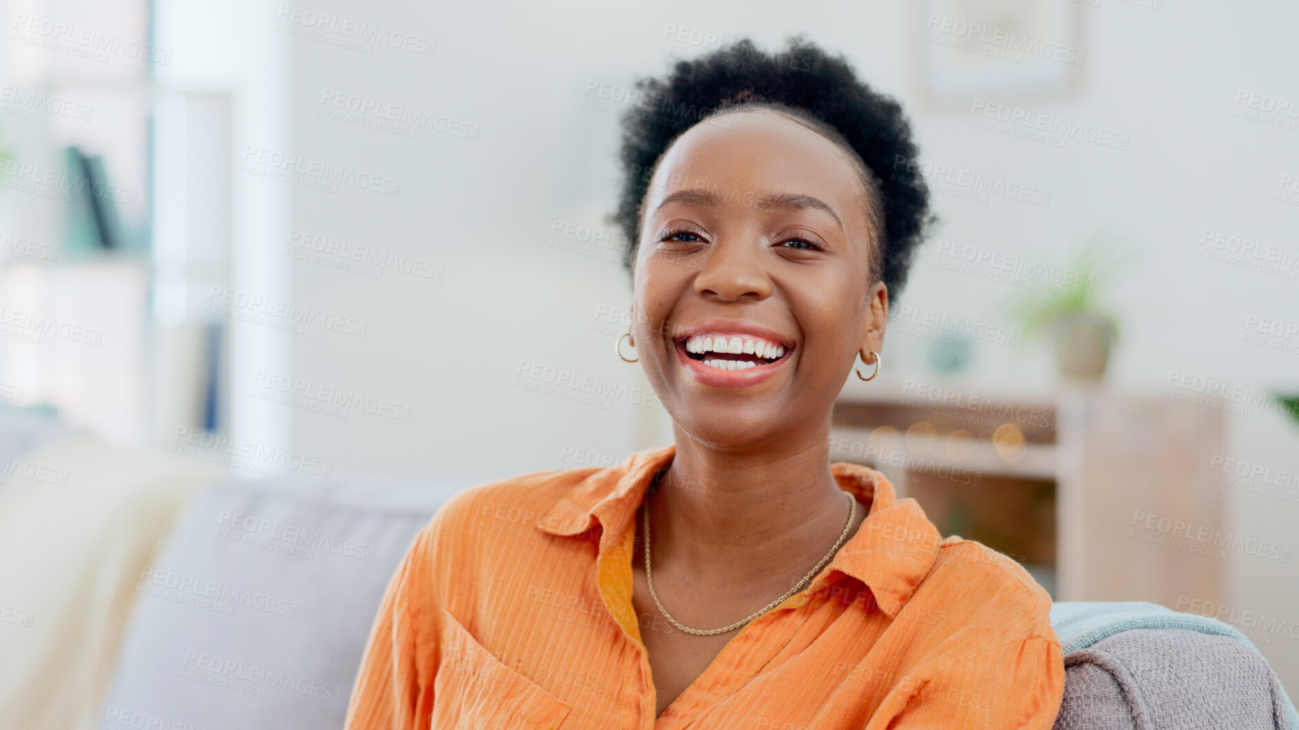 Buy stock photo Portrait, funny and a black woman laughing on a sofa in the living room of her home to relax on the weekend. Face, smile and comedy with a happy young person in her apartment to joke for humor