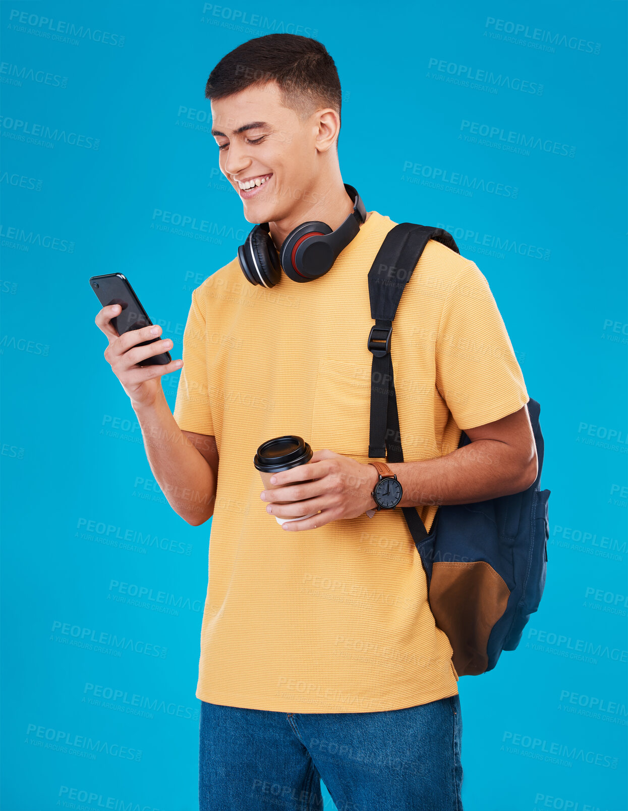 Buy stock photo Smile, phone and a student or man with a coffee on a blue background for social media. Happy, contact and a young gen z person reading from an app on a mobile with a website for education or learning
