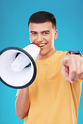 Buy stock photo Megaphone, happy and portrait of man in studio pointing for announcement, speech or rally. Smile, protest and young person from Canada with bullhorn for loud communication isolated by blue background