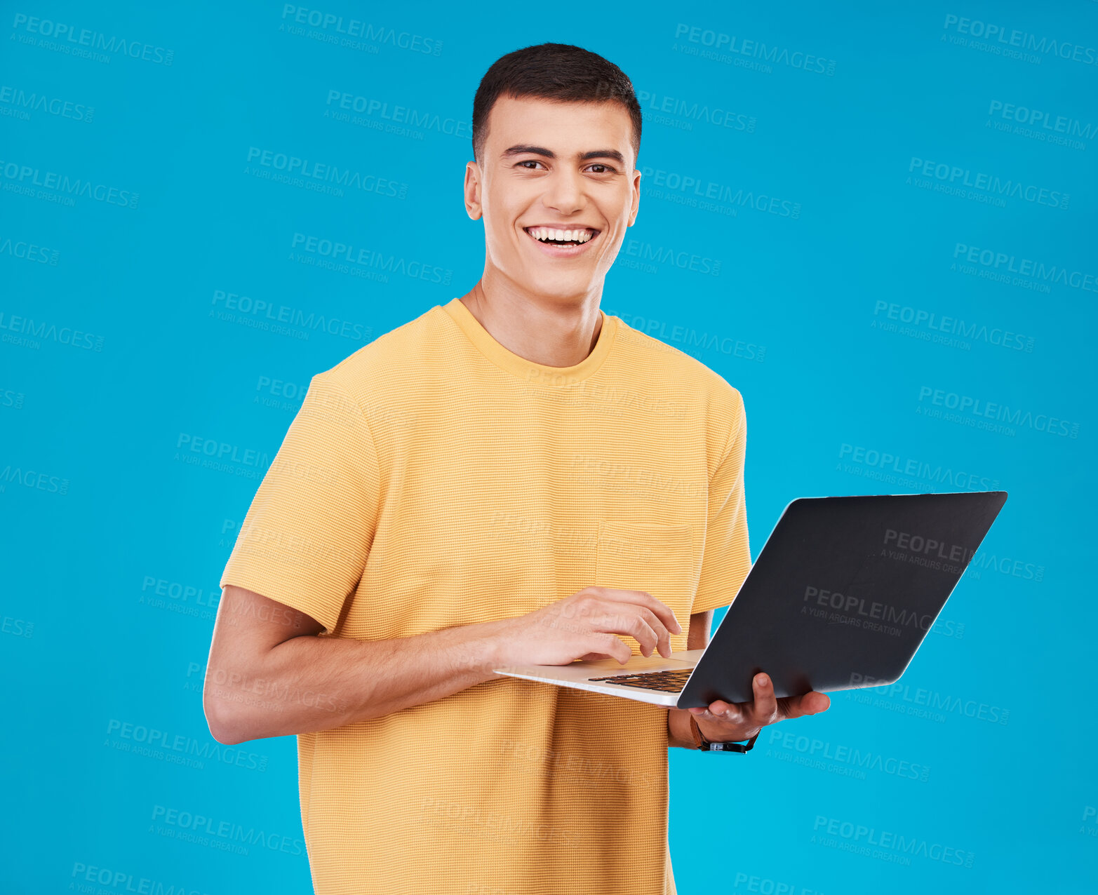 Buy stock photo Portrait, happy man or student with laptop in studio on blue background with mockup for e learning. Male model, person and smile with technology, typing or respond to email by online and work on web