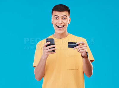 Buy stock photo Credit card, portrait and man with a cellphone, payment and transaction with savings on a blue background. Person, ecommerce and model with a smartphone, digital app and online banking with finance