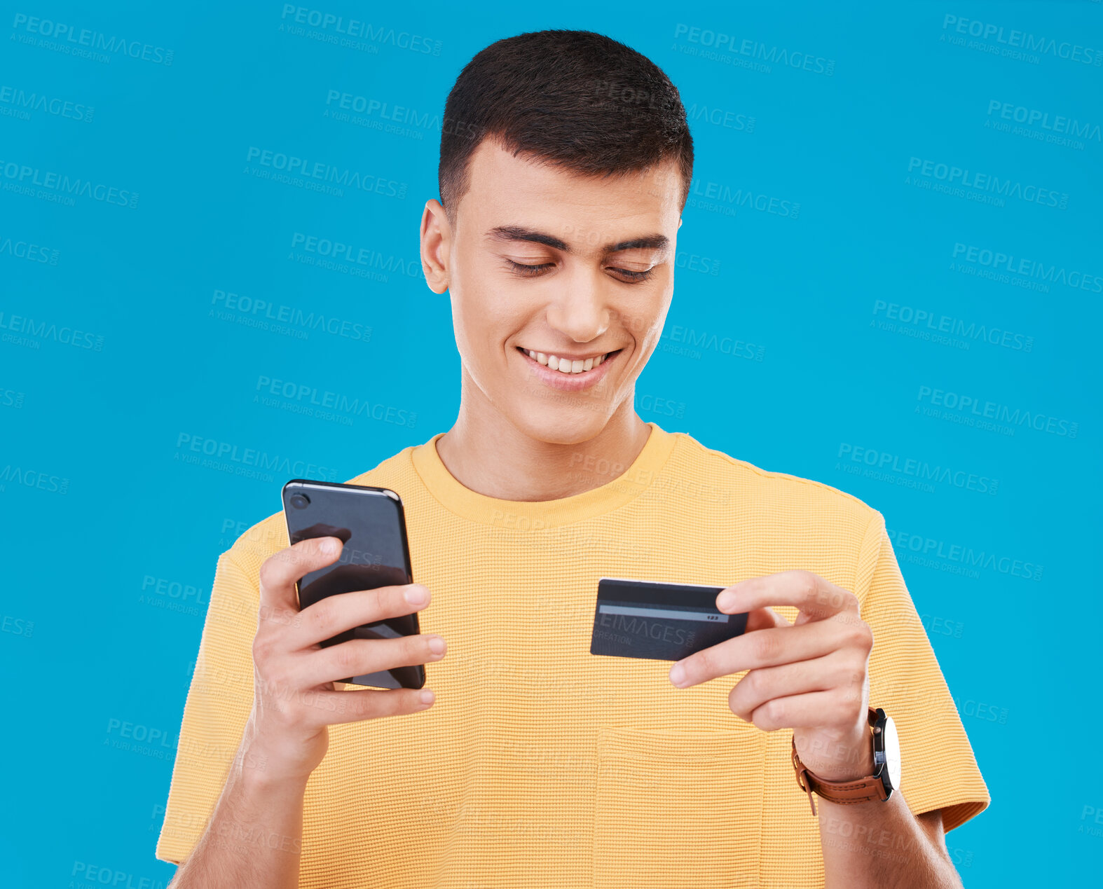 Buy stock photo Credit card, finance and man with a smartphone, payment and economy with digital app on a blue background. Person, guy or model with a cellphone, budget and online banking with transaction or savings