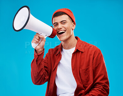Buy stock photo Portrait, megaphone and man with a smile, equality and promotion with a speech on a blue background. Person, activist and model with a bullhorn, change and happiness with freedom and mockup space