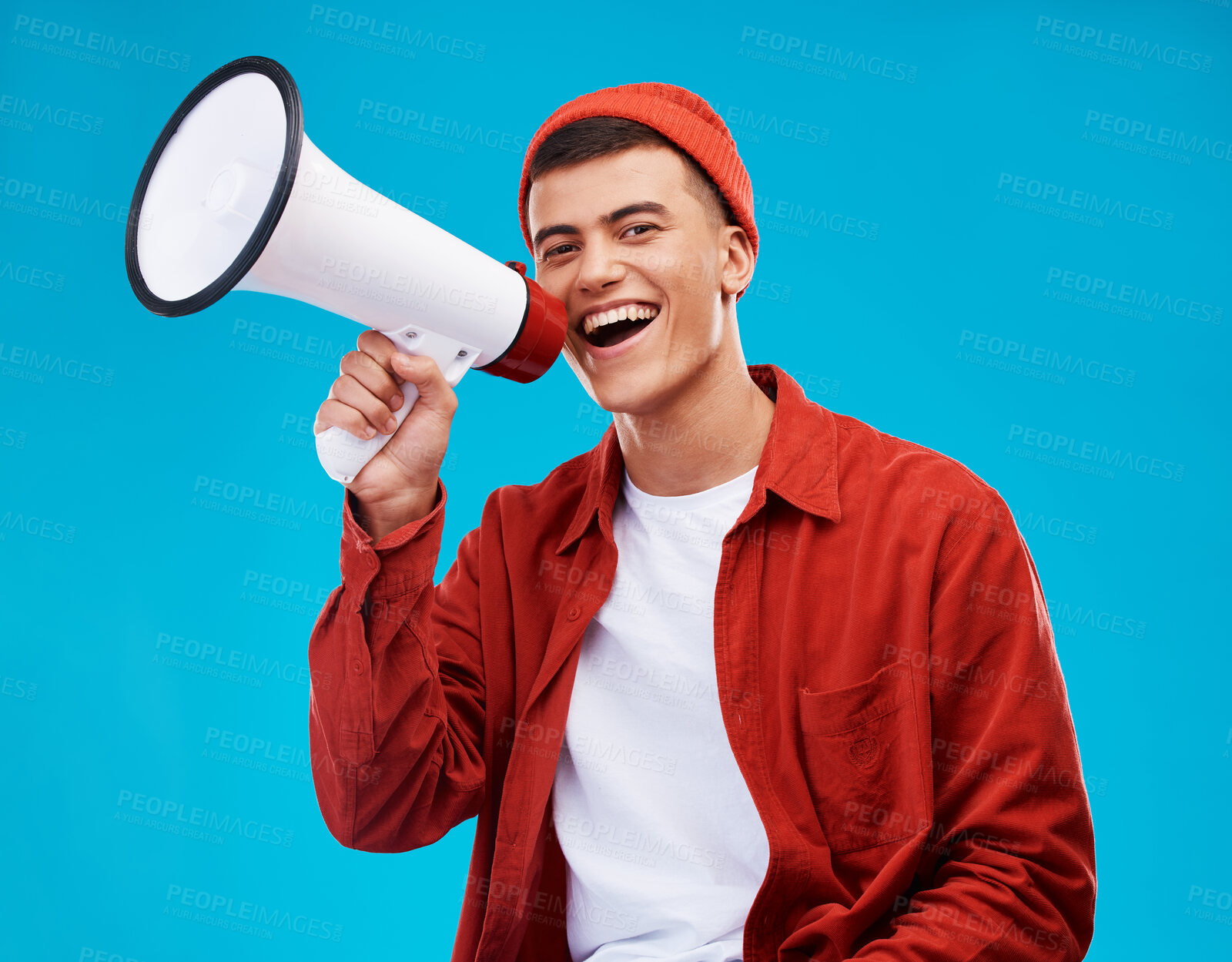 Buy stock photo Portrait, megaphone and man with a smile, equality and promotion with a speech on a blue background. Person, activist and model with a bullhorn, change and happiness with freedom and mockup space