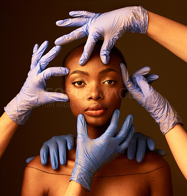 Buy stock photo Portrait, hands and plastic surgery on face of a black woman in studio on a dark background. Transformation, aesthetic or cosmetics and a young person getting ready for change with a team of doctors
