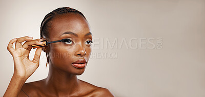 Buy stock photo Mascara, black woman and makeup in studio for beauty, cosmetics and mockup space on brown background. Banner, makeover and brush lashes for skincare application, aesthetic tools and eyelash product