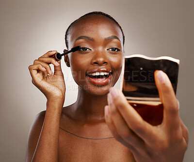 Buy stock photo Black woman, mascara with brush and mirror, makeup and shine with beauty isolated on brown background. Eyelash extension, wand and skin glow with cosmetology, transformation and wellness in studio