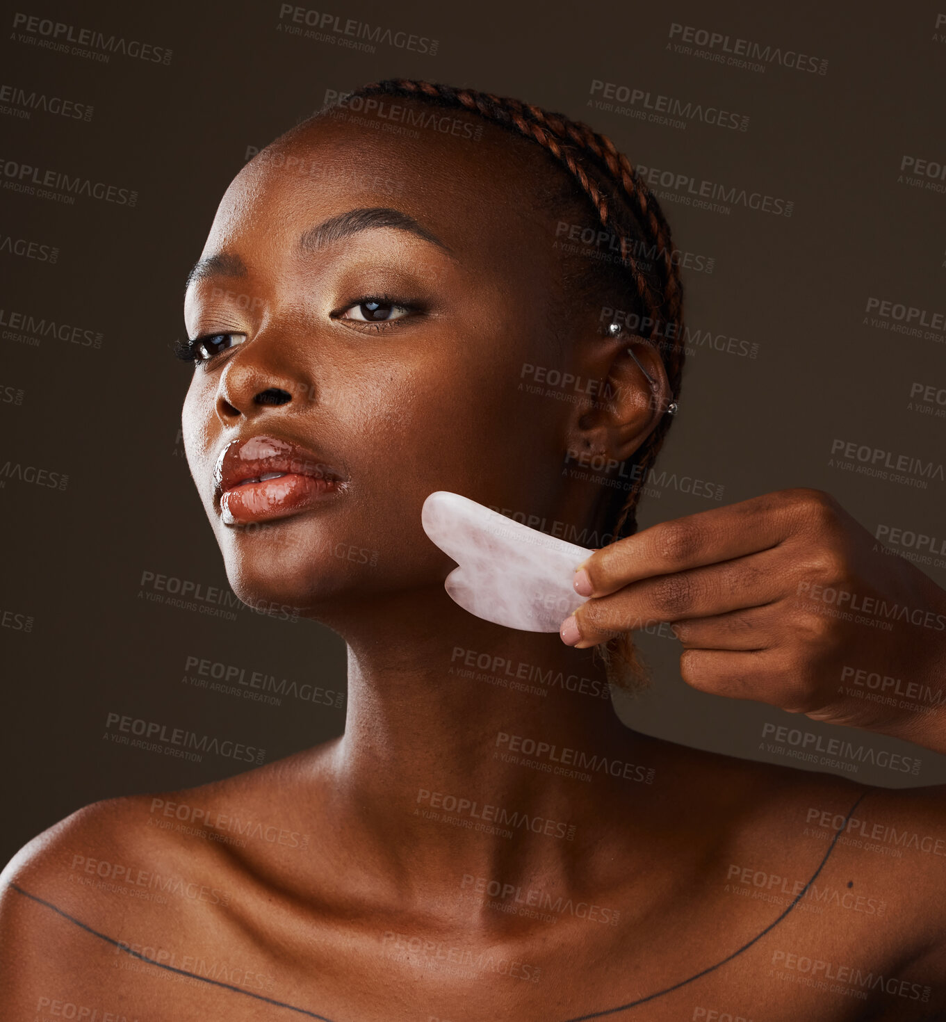 Buy stock photo Woman, facial and gua sha in hand on studio background for mockup in beauty, treatment or skincare. Black person, model or massage for glow, lymphatic drainage or grooming with tool, relax and shine